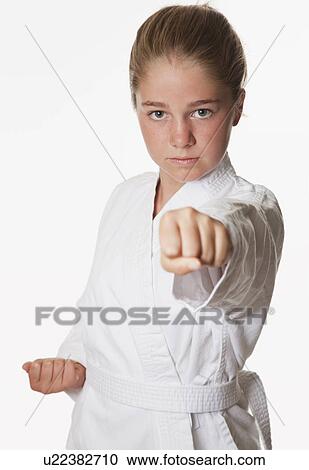 Stock Image - USA, California, Fairfax, Studio portrait of girl (10-11) wearing gi. Fotosearch