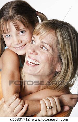 Stock Image - USA, California, Fairfax, Studio portrait of mother and daughter (8-9). Fotosearch