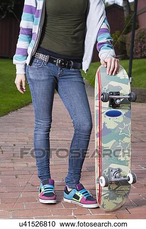USA California, Fairfax, teenage girl (16-17) with skateboard standing in park, low section View Large Photo Image Stock Image - USA California, Fairfax, teenage girl (16-17) with skateboard standing in park, low section. Fotosearch