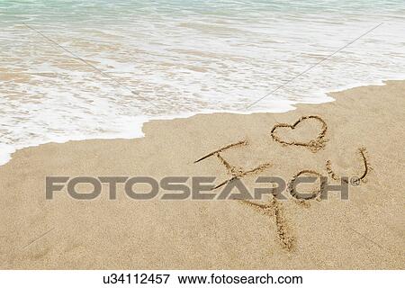 Stock Photo - USA, California, Hermosa Beach, I love you written in sand on beach. Fotosearch