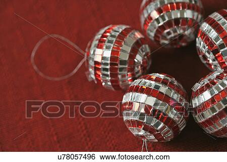Stock Photograph - USA, California, La Quinta, Christmas ornaments on red napkin. Fotosearch