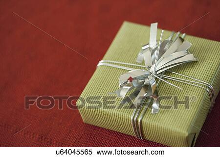 USA, California, La Quinta, Christmas present on red background View Large Photo Image Stock Photography - USA, California, La Quinta, Christmas present on red background. Fotosearch
