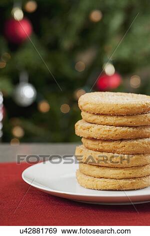 USA, California, La Quinta, Cookies on plate, defocused Christmas tree in background View Large Photo Image Stock Photo - USA, California, La Quinta, Cookies on plate, defocused Christmas tree in background. Fotosearch