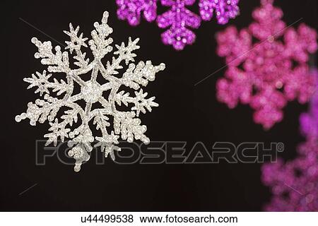 Stock Photo - USA, California, La Quinta, Shiny snowflakes against black background. Fotosearch