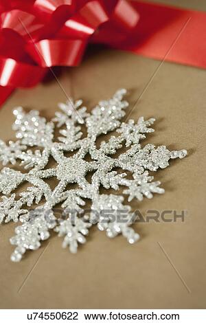 USA, California, La Quinta, Silver snowflake on Christmas present View Large Photo Image Stock Image - USA, California, La Quinta, Silver snowflake on Christmas present. Fotosearch