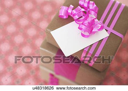 Stock Photograph - USA, California, La Quinta, Stack of gifts with greeting card. Fotosearch
