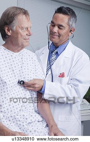 USA California, Larkspur, Doctor examining patient in hospital gown View Large Photo Image Stock Image - USA California, Larkspur, Doctor examining patient in hospital gown. Fotosearch