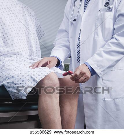 USA California, Larkspur, Doctor checking patient's reflexes with reflex hammer, mid section View Large Photo Image Stock Photo - USA California, Larkspur, Doctor checking patient's reflexes with reflex hammer, mid section. Fotosearch