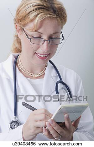 USA California, Larkspur, Female doctor writing prescription View Large Photo Image Stock Photograph - USA California, Larkspur, Female doctor writing prescription. Fotosearch