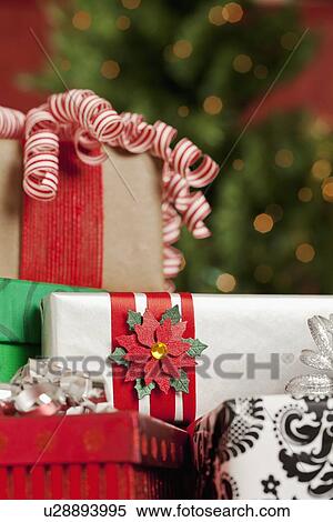 Stock Photography - USA, California, Lawndale, Christmas gifts, illuminated Christmas tree in background. Fotosearch