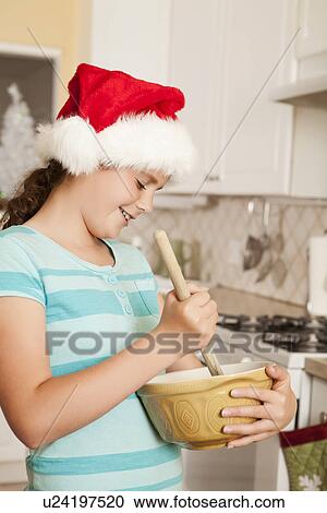 USA, California, Lawndale, Girl (10-11) wearing santa hat stirring dough View Large Photo Image Stock Image - USA, California, Lawndale, Girl (10-11) wearing santa hat stirring dough. Fotosearch