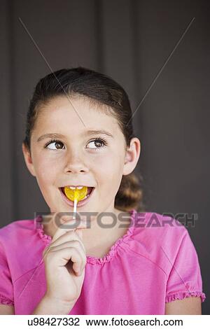 USA, California, Lawndale, Girl (8-9) with lollipop View Large Photo Image Stock Image - USA, California, Lawndale, Girl (8-9) with lollipop. Fotosearch