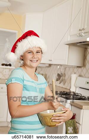 USA, California, Lawndale, Portrait of girl (10-11) wearing santa hat stirring dough View Large Photo Image Stock Image - USA, California, Lawndale, Portrait of girl (10-11) wearing santa hat stirring dough. Fotosearch