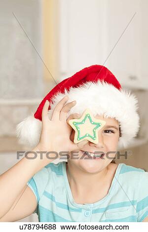 USA, California, Lawndale, Portrait of girl (10-11) wearing santa hat holding cookie View Large Photo Image Stock Photo - USA, California, Lawndale, Portrait of girl (10-11) wearing santa hat holding cookie. Fotosearch