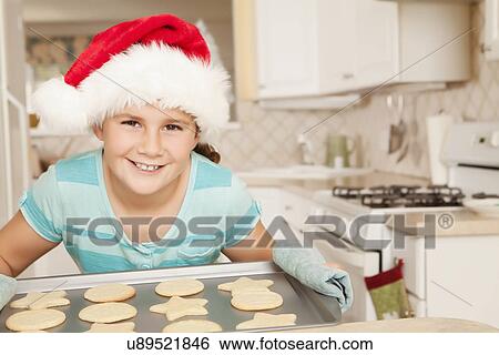 USA, California, Lawndale, Portrait of girl (10-11) wearing santa hat holding tray of cookies View Large Photo Image Stock Photograph - USA, California, Lawndale, Portrait of girl (10-11) wearing santa hat holding tray of cookies. Fotosearch