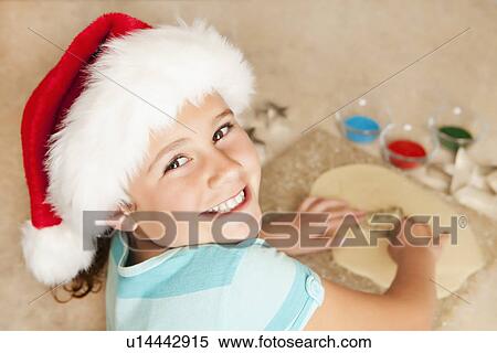 USA, California, Lawndale, Portrait of girl (10-11) wearing santa hat using pastry cutter View Large Photo Image Stock Photography - USA, California, Lawndale, Portrait of girl (10-11) wearing santa hat using pastry cutter. Fotosearch