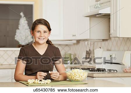 USA, California, Lawndale, Portrait of girl (10-11) sewing popcorn onto string View Large Photo Image Stock Photography - USA, California, Lawndale, Portrait of girl (10-11) sewing popcorn onto string. Fotosearch