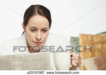 USA, California, Lawndale, Woman drinking coffee and reading newspaper View Large Photo Image Stock Photo - USA, California, Lawndale, Woman drinking coffee and reading newspaper. Fotosearch