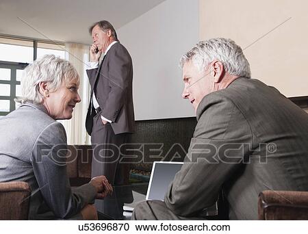 USA, California, Mill Valley, Business man and woman talking in hotel lobby View Large Photo Image Stock Image - USA, California, Mill Valley, Business man and woman talking in hotel lobby. Fotosearch