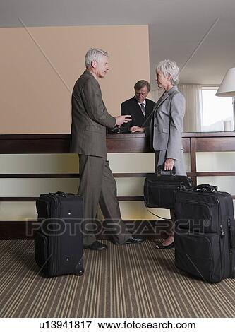 USA, California, Mill Valley, Business man and woman at hotel reception View Large Photo Image Stock Photo - USA, California, Mill Valley, Business man and woman at hotel reception. Fotosearch