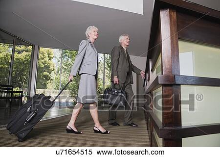 USA, California, Mill Valley, Business man and woman at hotel reception View Large Photo Image Stock Photography - USA, California, Mill Valley, Business man and woman at hotel reception. Fotosearch