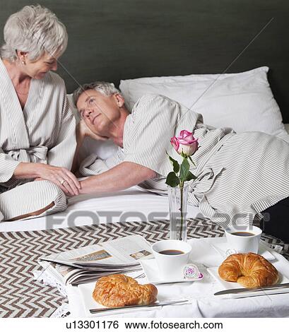 USA, California, Mill Valley, Couple relaxing on bed with breakfast View Large Photo Image Stock Photograph - USA, California, Mill Valley, Couple relaxing on bed with breakfast. Fotosearch