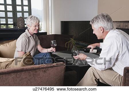 USA, California, Mill Valley, Couple drinking wine in living room View Large Photo Image Stock Photography - USA, California, Mill Valley, Couple drinking wine in living room. Fotosearch