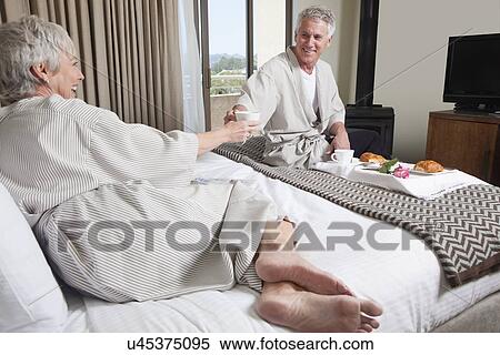 USA, California, Mill Valley, Couple relaxing on bed with breakfast View Large Photo Image Stock Photography - USA, California, Mill Valley, Couple relaxing on bed with breakfast. Fotosearch