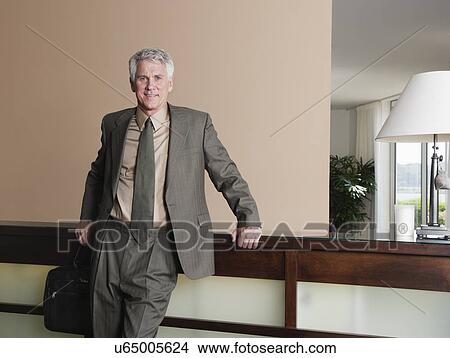 USA, California, Mill Valley, Businessman at hotel reception View Large Photo Image Picture - USA, California, Mill Valley, Businessman at hotel reception. Fotosearch