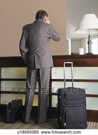 Stock Image - USA, California, Mill Valley, Businessman waiting at hotel reception. Fotosearch