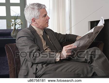 Stock Image - USA, California, Mill Valley, Businessman reading newspaper. Fotosearch