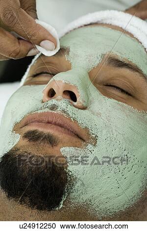 USA, California, Oakland, beautician removing facial mask from man's face in spa View Large Photo Image Stock Image - USA, California, Oakland, beautician removing facial mask from man's face in spa. Fotosearch