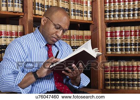 USA, California, Oakland, Man reading books in library View Large Photo Image Stock Image - USA, California, Oakland, Man reading books in library. Fotosearch