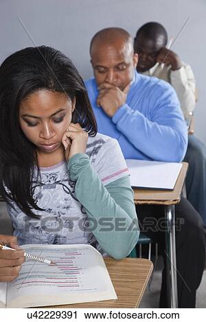 Stock Image - USA, California, Oakland, Students writing exam. Fotosearch