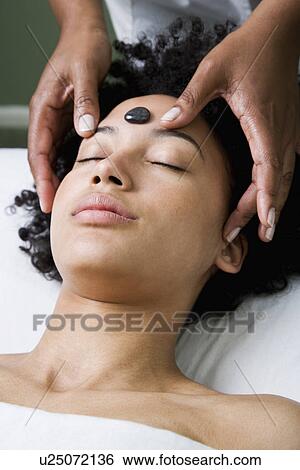 USA, California, Oakland, young woman receiving stone spa treatment View Large Photo Image Stock Photograph - USA, California, Oakland, young woman receiving stone spa treatment. Fotosearch