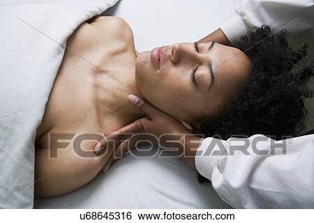 Stock Photograph - USA, California, Oakland, young woman having neck massage. Fotosearch