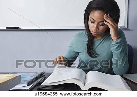USA, California, Oakland, Young woman reading textbox View Large Photo Image Stock Photography - USA, California, Oakland, Young woman reading textbox. Fotosearch