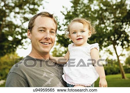 USA, California, Rancho Cucamonga, Portrait of father with daughter (12-17 months) View Large Photo Image Stock Photography - USA, California, Rancho Cucamonga, Portrait of father with daughter (12-17 months). Fotosearch