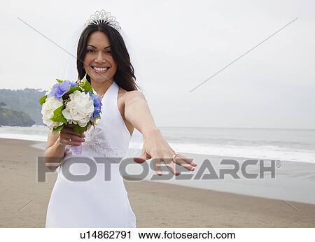 Stock Image - USA, California, San Francisco, Baker Beach, portrait of bride on beach. Fotosearch