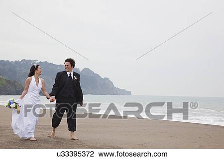USA, California, San Francisco, Baker Beach, bride and groom walking on beach View Large Photo Image Stock Image - USA, California, San Francisco, Baker Beach, bride and groom walking on beach. Fotosearch