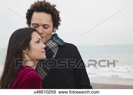 Stock Photo - USA, California, San Francisco, Baker Beach, couple embracing on beach. Fotosearch