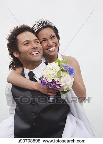 Stock Photo - USA, California, San Francisco, Baker Beach, portrait of bride and groom. Fotosearch