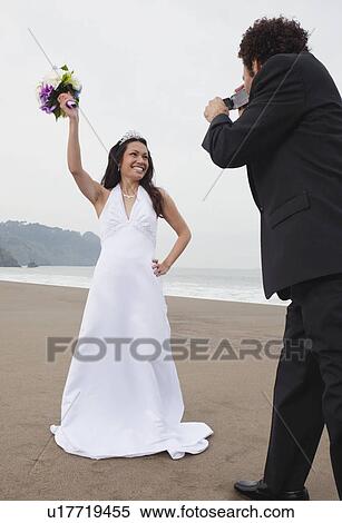 USA, California, San Francisco, Baker Beach, groom filming bride on beach View Large Photo Image Stock Photography - USA, California, San Francisco, Baker Beach, groom filming bride on beach. Fotosearch