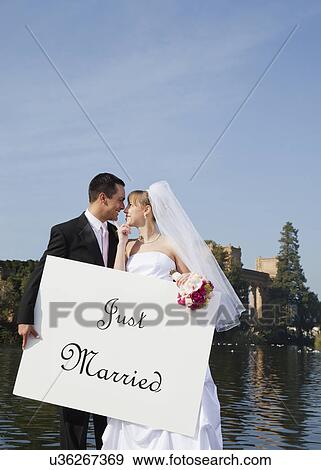 USA, California, San Francisco, bride and groom holding just married sign View Large Photo Image Stock Photo - USA, California, San Francisco, bride and groom holding just married sign. Fotosearch