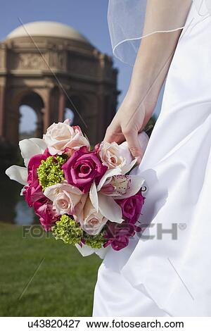 USA, California, San Francisco, bride holding bouquet outdoors View Large Photo Image Stock Photo - USA, California, San Francisco, bride holding bouquet outdoors. Fotosearch