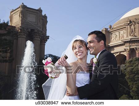 USA, California, San Francisco, bride and groom embracing near fountain View Large Photo Image Stock Photo - USA, California, San Francisco, bride and groom embracing near fountain. Fotosearch