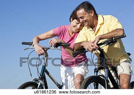 USA, California, San Francisco, Couple with bicycles standing against blue sky View Large Photo Image Stock Photograph - USA, California, San Francisco, Couple with bicycles standing against blue sky. Fotosearch