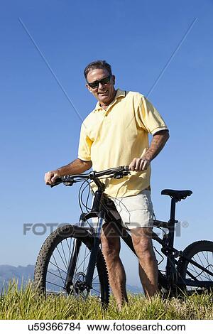 USA, California, San Francisco, Cyclist standing against blue sky View Large Photo Image Picture - USA, California, San Francisco, Cyclist standing against blue sky. Fotosearch