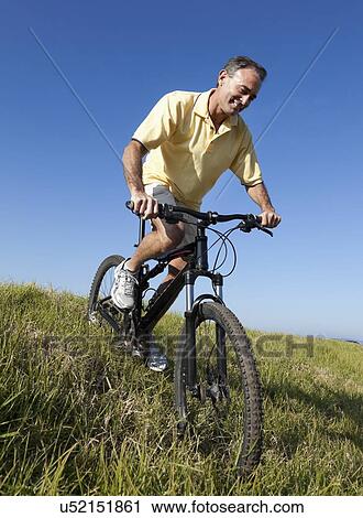 USA, California, San Francisco, Cyclist standing against blue sky View Large Photo Image Stock Image - USA, California, San Francisco, Cyclist standing against blue sky. Fotosearch