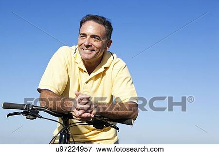 USA, California, San Francisco, Cyclist standing against blue sky View Large Photo Image Stock Photo - USA, California, San Francisco, Cyclist standing against blue sky. Fotosearch